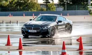 BMW fährt auf nasser Strecke, Wasser spritzt. Bridgestone Turanza 6 Test auf dem Prüfstand.