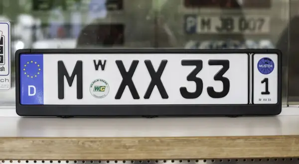 Deutsches Wechselkennzeichen für ein Motorrad, M XX 33, mit EU-Sternen und Prüfplakette.