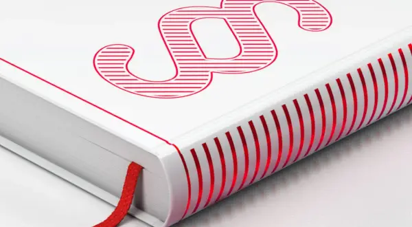 Ein weißes Buch mit rotem Paragraphenzeichen und rotem Lesezeichen. Die Seitenkanten sind ebenfalls rot gestreift. Ein Symbol für Gesetze und Regeln.